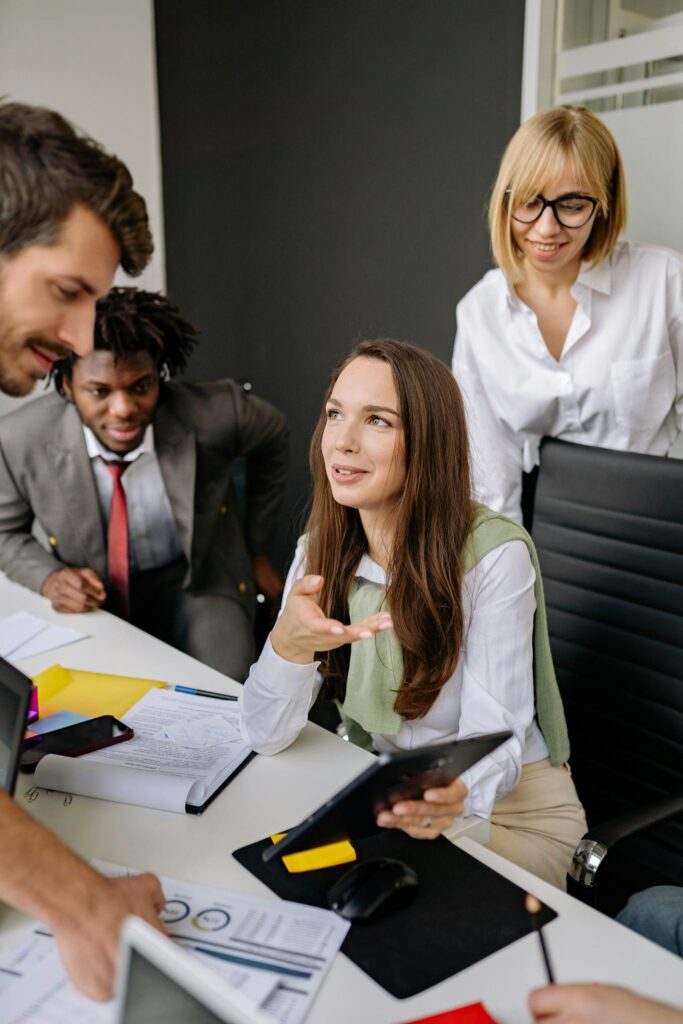 A multi-ethnic team brainstorming and collaborating in a modern office setting.